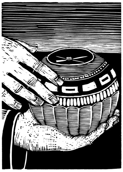 Black and white woodcut of a a carved ball with a compass being held by a hand.